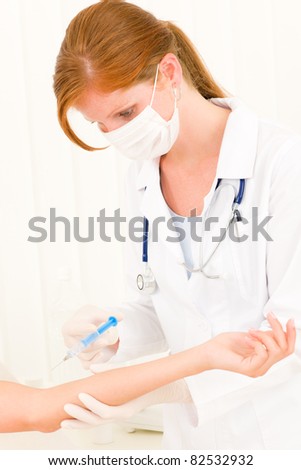 Female medical doctor white protective clothes apply injection to patient