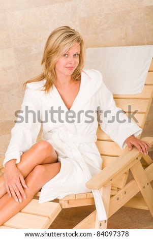 Relax luxury spa beauty woman in white bathrobe sitting on sun-bed