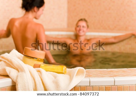 Spa and beauty products two naked women inside pool water beauty health