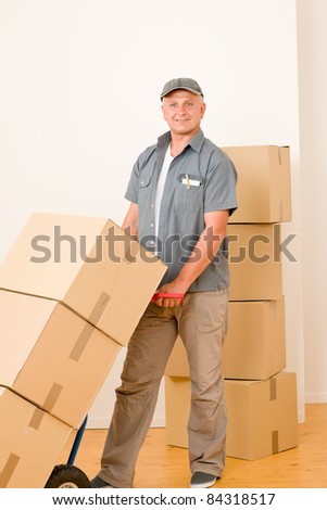 Friendly messenger or mover delivering parcel boxes on hand truck