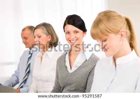 Young businesswoman smiling meeting with team colleagues