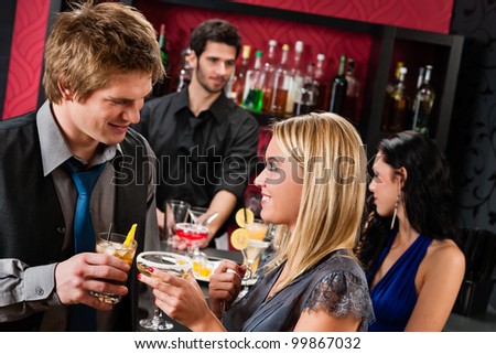 Cocktail bar young happy couple friends enjoy drinks