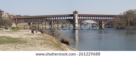 Pavia, Italy: Covered bridge over the river Ticino. Very quaint, has five arches and is completely covered with two portals at the ends and a small chapel religious center.