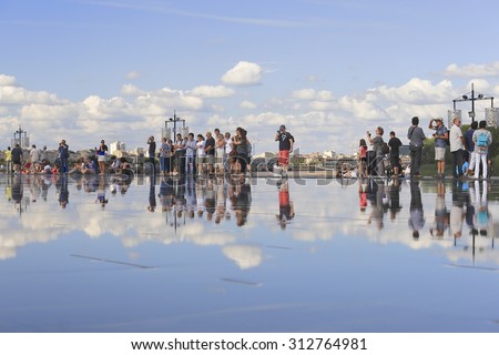 BORDEAUX, FRANCE - 4 August, 2015 : Bordeaux water mirror full of people in one of the hotest summer days, having fun in the water, the pool is the largest water mirror in the world with 3450 sq.m.
