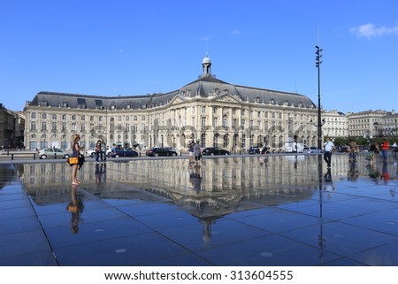 BORDEAUX, FRANCE - 1 August, 2015 : Bordeaux water mirror full of people in one of the hotest summer days, having fun in the water, the pool is the largest water mirror in the world with 3450 sq.m.
