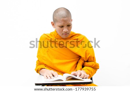 Buddhist monk reading a religious text in Thailand.