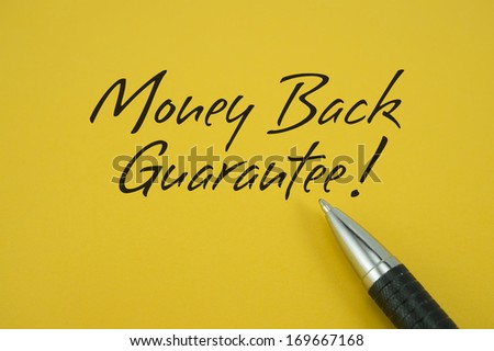 Money Back Guarantee note with pen on yellow background