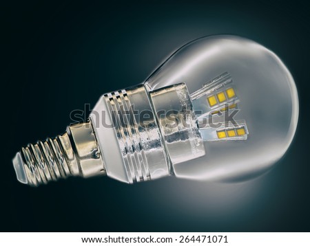 Led lamp closeup on dark background. Shining saving energy bulb.