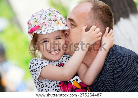 Father's day. Dad kissing his daughter.Happy smiling child with parent. Family portrait.