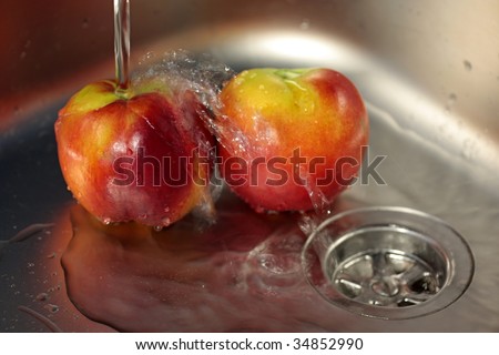Washing Fruit in stainless steel sink