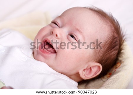 Cute baby girl laughing with toothless smile