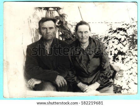 USSR  - CIRCA 1948: An antique photo shows man and a middle-aged woman sitting in the garden