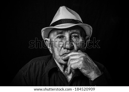 photo senior male retired wearing a hat on black
