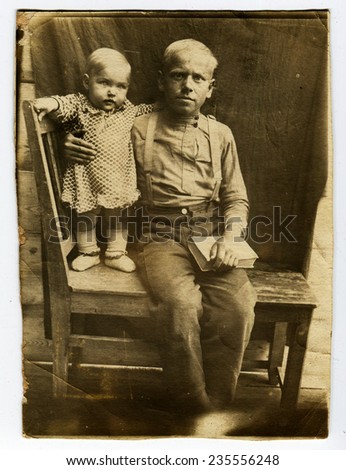 Ussr - CIRCA 1930s: An antique Black & White photo show father with a small daughter