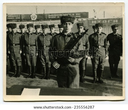 Ussr - CIRCA 1970s: An antique Black & White photo show soldier with a gun takes the oath of allegiance