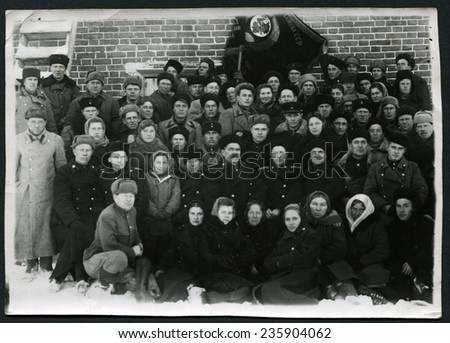 Ussr - CIRCA 1950s: An antique Black & White photo show portrait of a group people with flag ussr