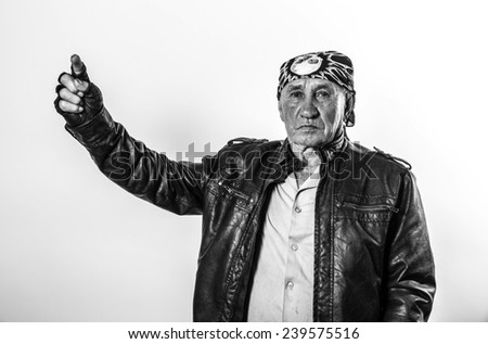 Portrait of an old man biker pointing finger up