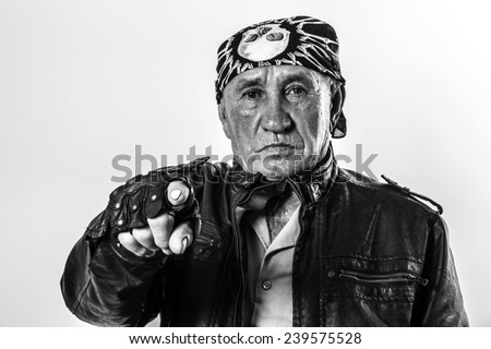 Portrait of an old man biker pointing a finger at you