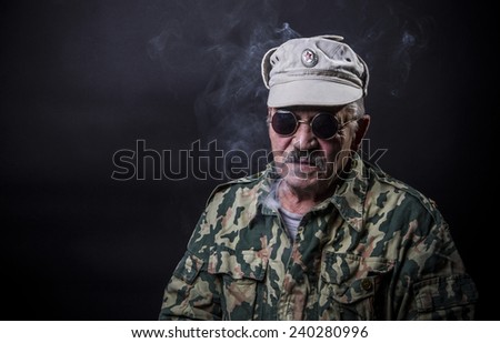 Old man with glasses and camouflage