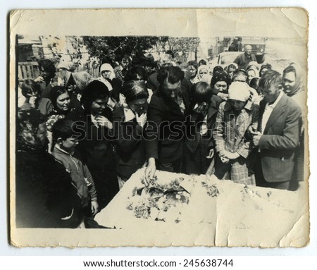 Ussr - CIRCA 1970s: An antique Black & White photo show People near the grave