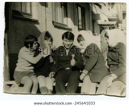 Ussr - CIRCA 1970s: An antique Black & White photo show group of young people on a bench
