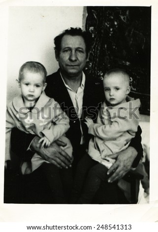 USSR - CIRCA 1980s: An antique Black & White photo show father and two sons