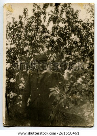 Ussr - CIRCA 1980s: An antique Black & White photo show man in the garden