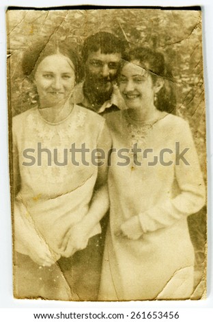 Ussr - CIRCA 1930s: An antique Black & White photo show two young woman and boy