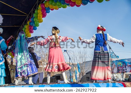 PETROPAVLOVSK, KAZAKHSTAN - MARCH 21, 2015: celebration of the new year on the solar calendar astronomical in Iranian and Turkic peoples. Girls in dresses international