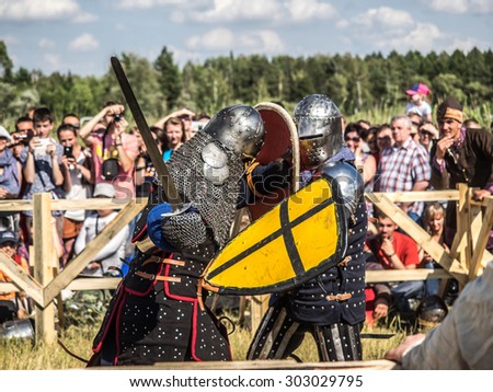 OMSK, RUSSIA - AUGUST 1, 2015: Unidentified participants in medieval fight at a historical reenactment festival \