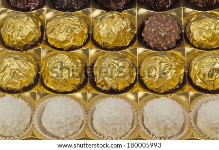 Fragment of the open blue boxes of chocolates. Presented on a white background