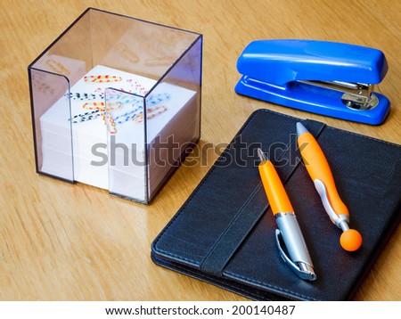 Two beautiful handles for the letter, a stapler, the laptop and scratch paper lie on a table.
