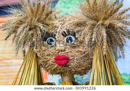 Funny doll made of straw and ears of wheat with eyes , eyelashes, mouth of papier-mache.
