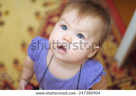 Surprised little girl looking up with wide eyes
