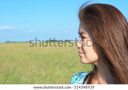 Asian woman in 30\'s looking left far away