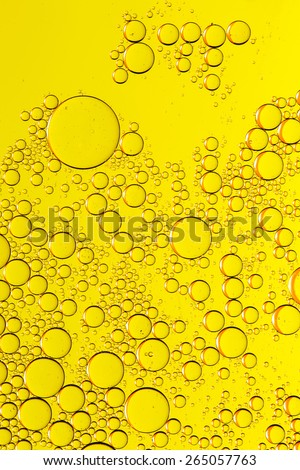 Abstract yellow fluid with bubbles. Water drops. Sparkling fluid.