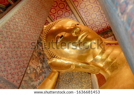 Golden Buddha statue in buddhist temple in public area allowed zones, Big sculpture represent of buddhism, Reclining Buddha at Wat Phra Chetuphon (Wat Pho) Bangkok, Thailand. Zdjęcia stock © 