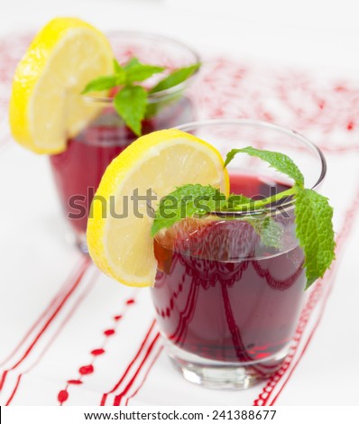 Summer drinks, two glasses of red fruit juice with lemon
