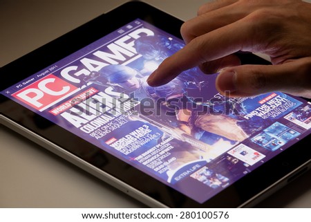 Hong Kong, China - August 7, 2011: Reading PC Gamer magazine on an iPad running the Zinio app. Zinio is a publishing technology and services company, which provides sales and distribution of printed