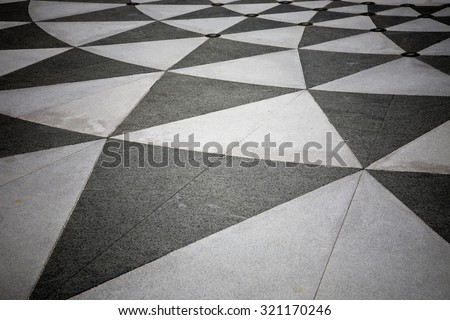 Tiled floor with black and grey triangular pattern
