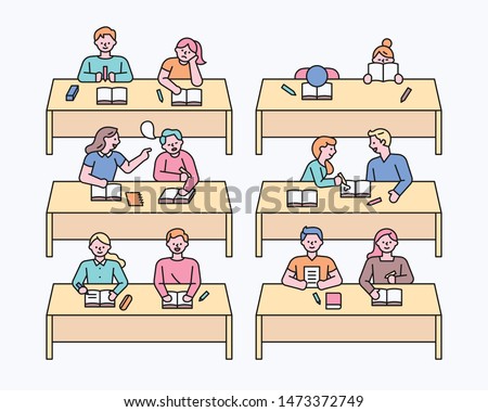 Children sitting at the classroom desk. flat design style minimal vector illustration.