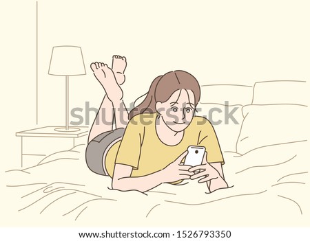 A girl is lying on the bed and looking at the phone. hand drawn style vector design illustrations. 