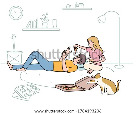 A couple is eating pizza in the living room. A cat is trying to steal pizza. hand drawn style vector design illustrations. 