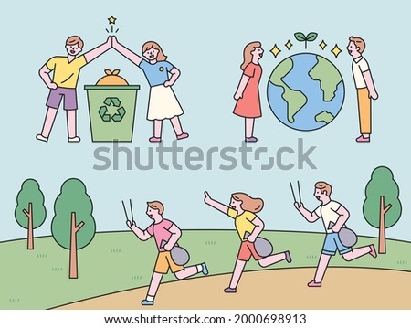 People collecting and high fives for recycling. People standing with the Earth in between. People jogging and picking up trash. flat design style minimal vector illustration.