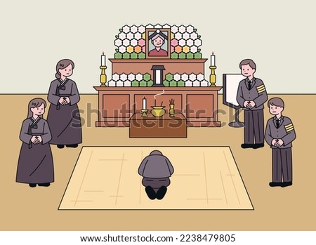 Funeral home in Korea. There is an altar with a picture of the deceased. The bereaved are standing and visitors are bowing.