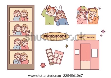 Take pictures at the photo booth. Friends and couples wearing funny headbands and doing cute poses.