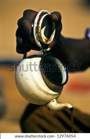 Touareg hand pouring the tea in a camp