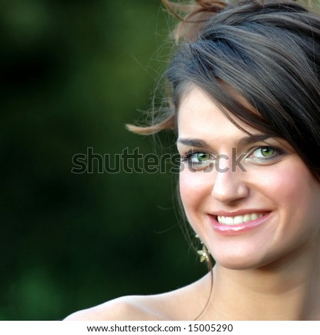 Beautiful smiling young woman with green eyes on green background 02