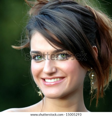Beautiful smiling young woman with green eyes on green background 03