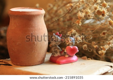 old clay jug of milk dry food health daisy flowers book statuette cat kitten heart love romance Breakfast
